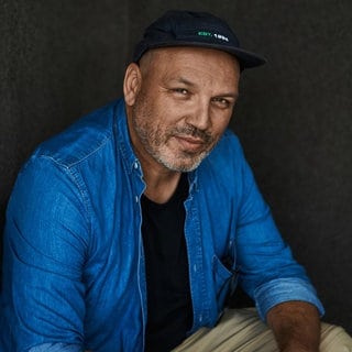 Mode- und Musikfotograf Axl Jansen blickt in die Kamera.